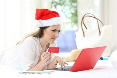 Christmas scams - woman using a laptop.