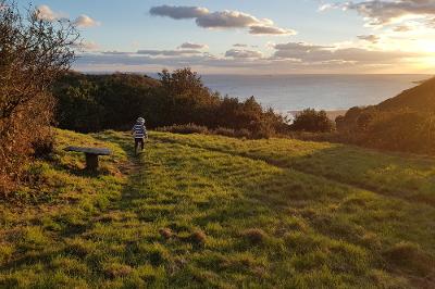 Young boy walking on the path overlooking Caswell.